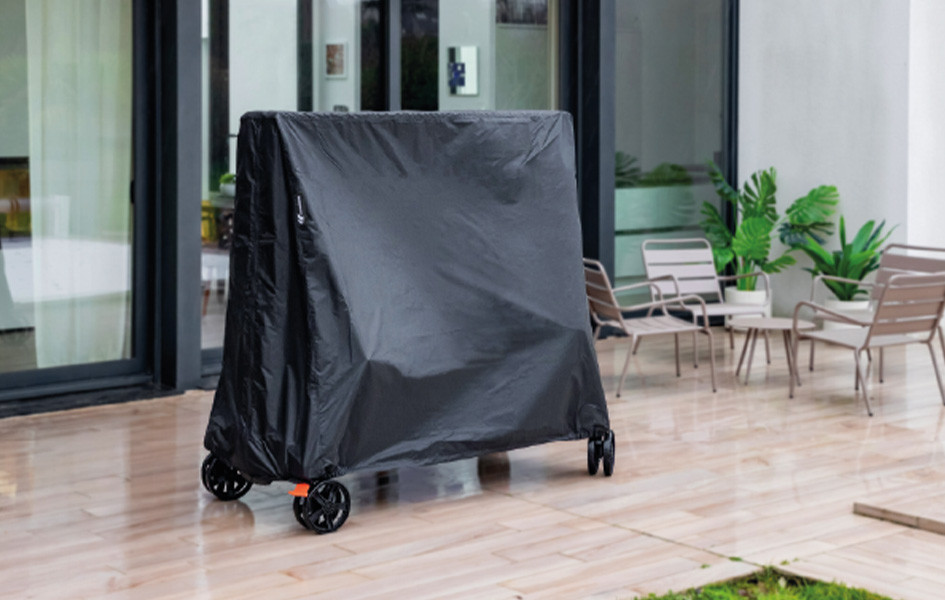 Waterproof Cornilleau protective cover for a ping-pong table on a private patio