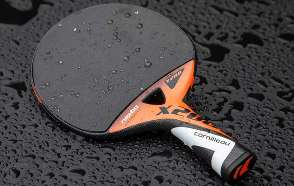 Outdoor ping-pong paddle on a table in the rain